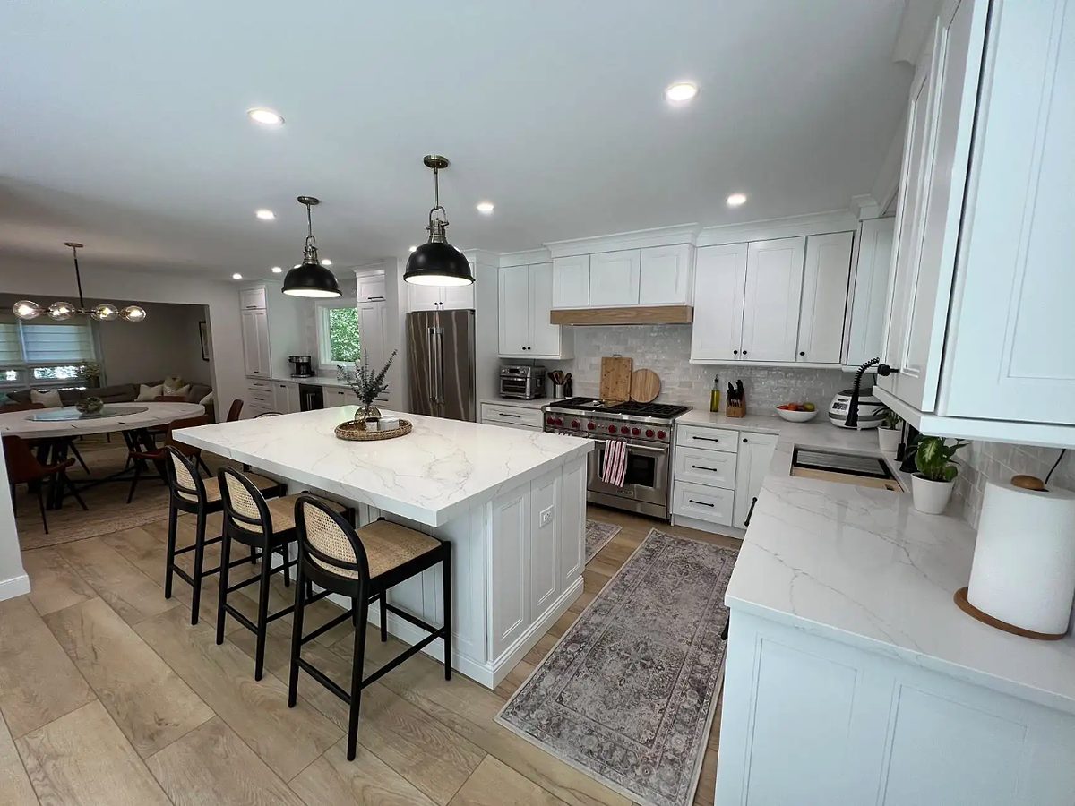 21st Century Cabinetry white shaker kitchen with a quartz island — manufacturer photo