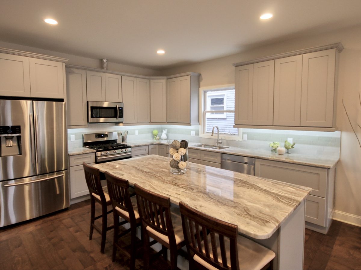 FGM Cabinetry gray shaker kitchen with a granite island — manufacturer photo