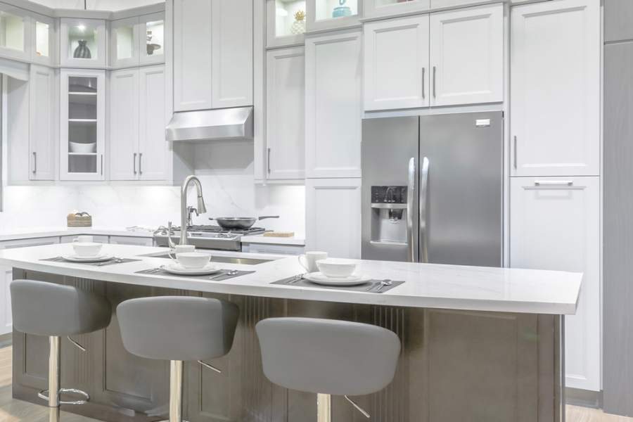 Adornus Designer Series white kitchen with a marble-look island — manufacturer photo