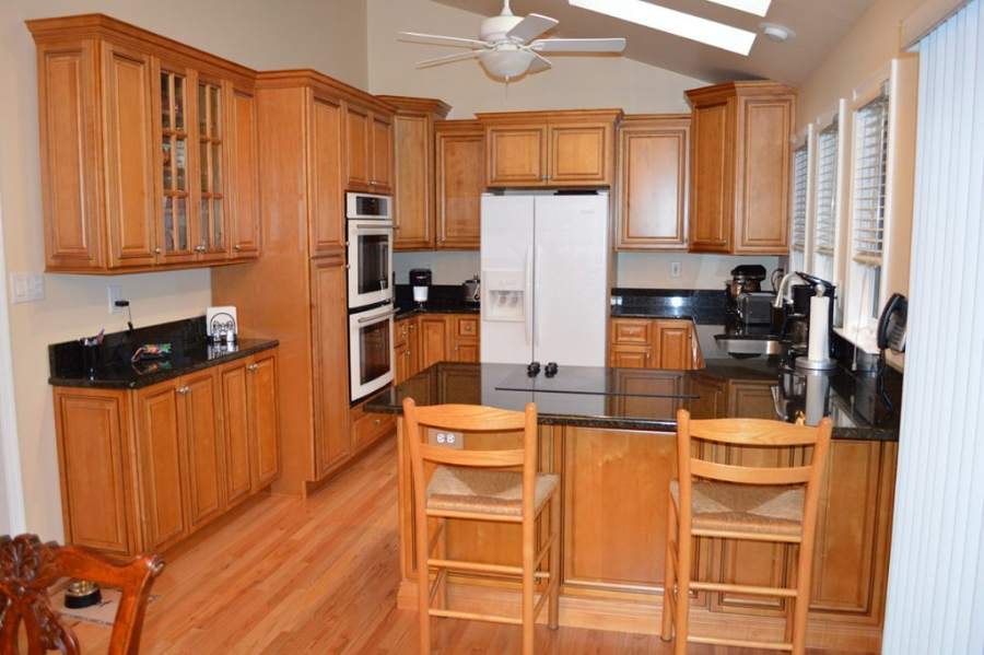 21st Century natural maple kitchen with a breakfast bar — manufacturer photo
