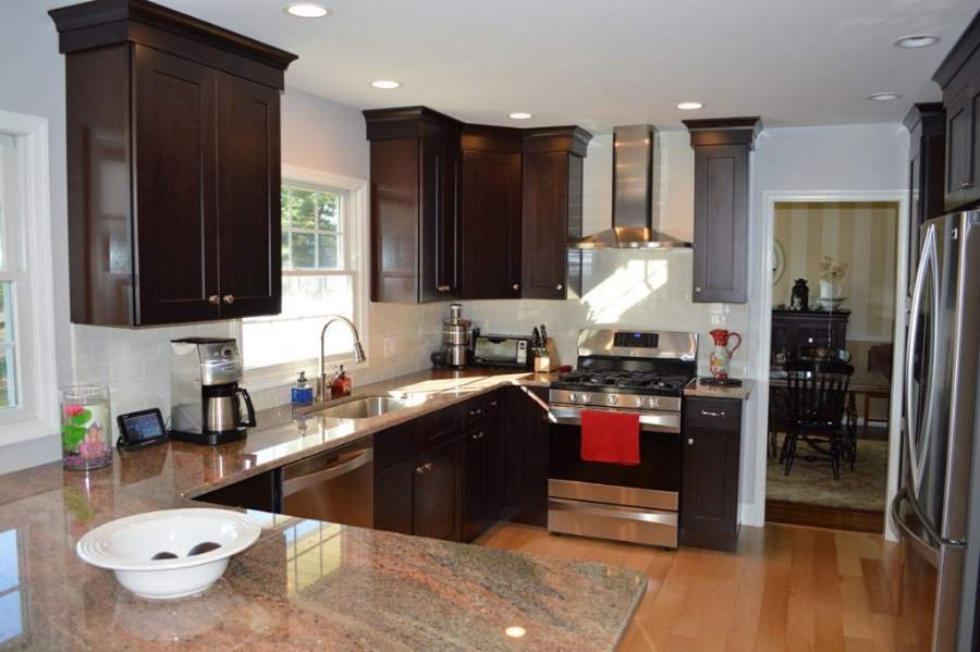 21st Century dark shaker kitchen with a granite peninsula — manufacturer photo