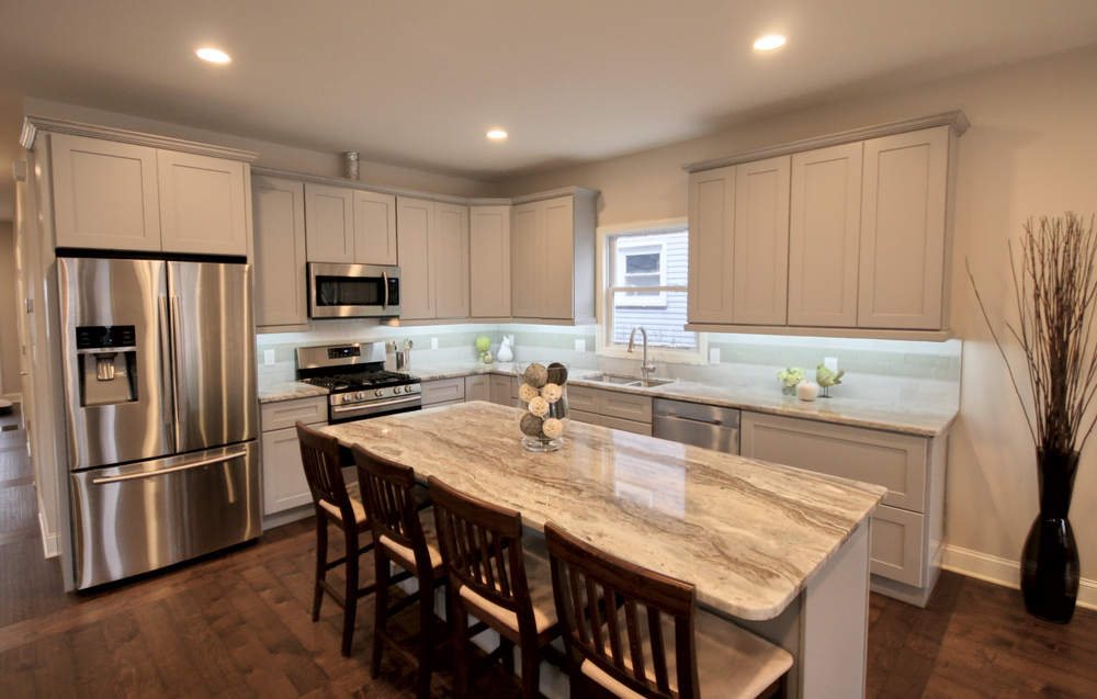 FGM white shaker kitchen with a granite island — manufacturer photo