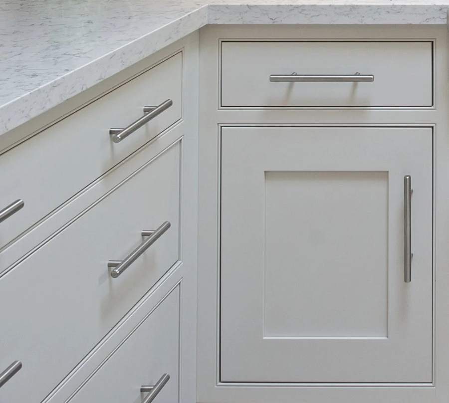 Great Northern maple in Frosty White, Shakertown II doors with slab drawers — manufacturer photo