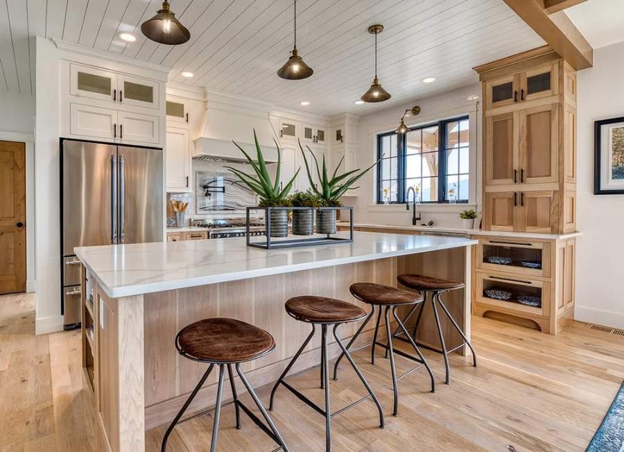 Great Northern opaque white uppers with custom-stained hickory bases and island — manufacturer photo