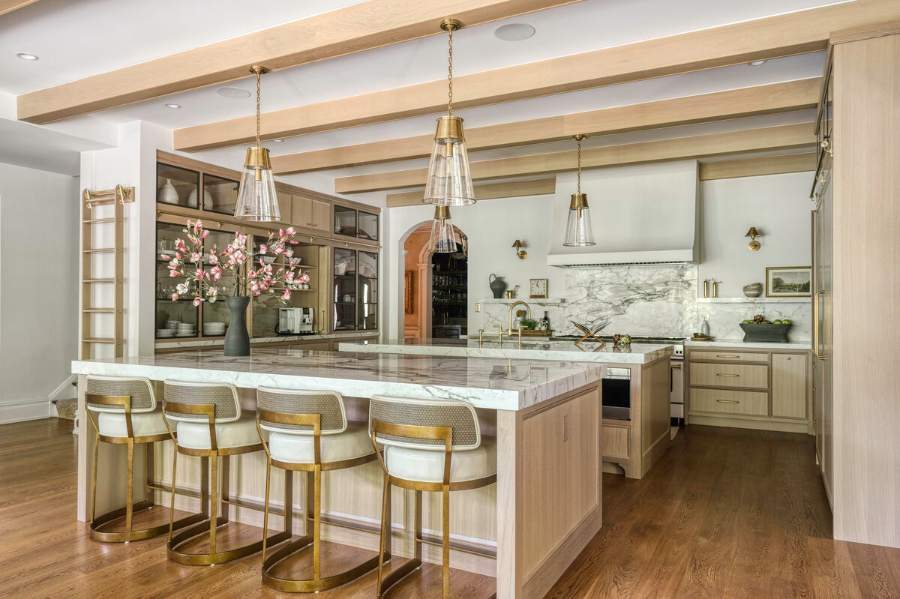 Plain & Fancy white oak kitchen with a marble island and brass stools — manufacturer photo