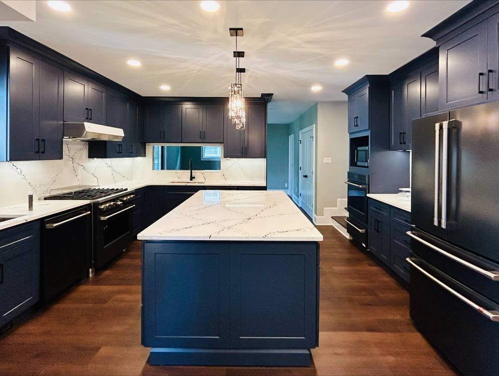 WoodConcept Element Ocean navy kitchen with a marble-look island — manufacturer photo
