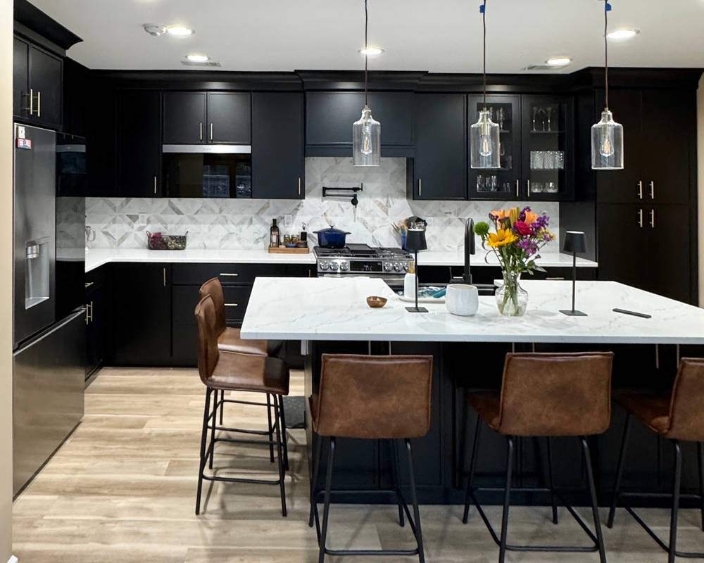 WoodConcept Profile Caviar black kitchen with a white island and leather stools — manufacturer photo