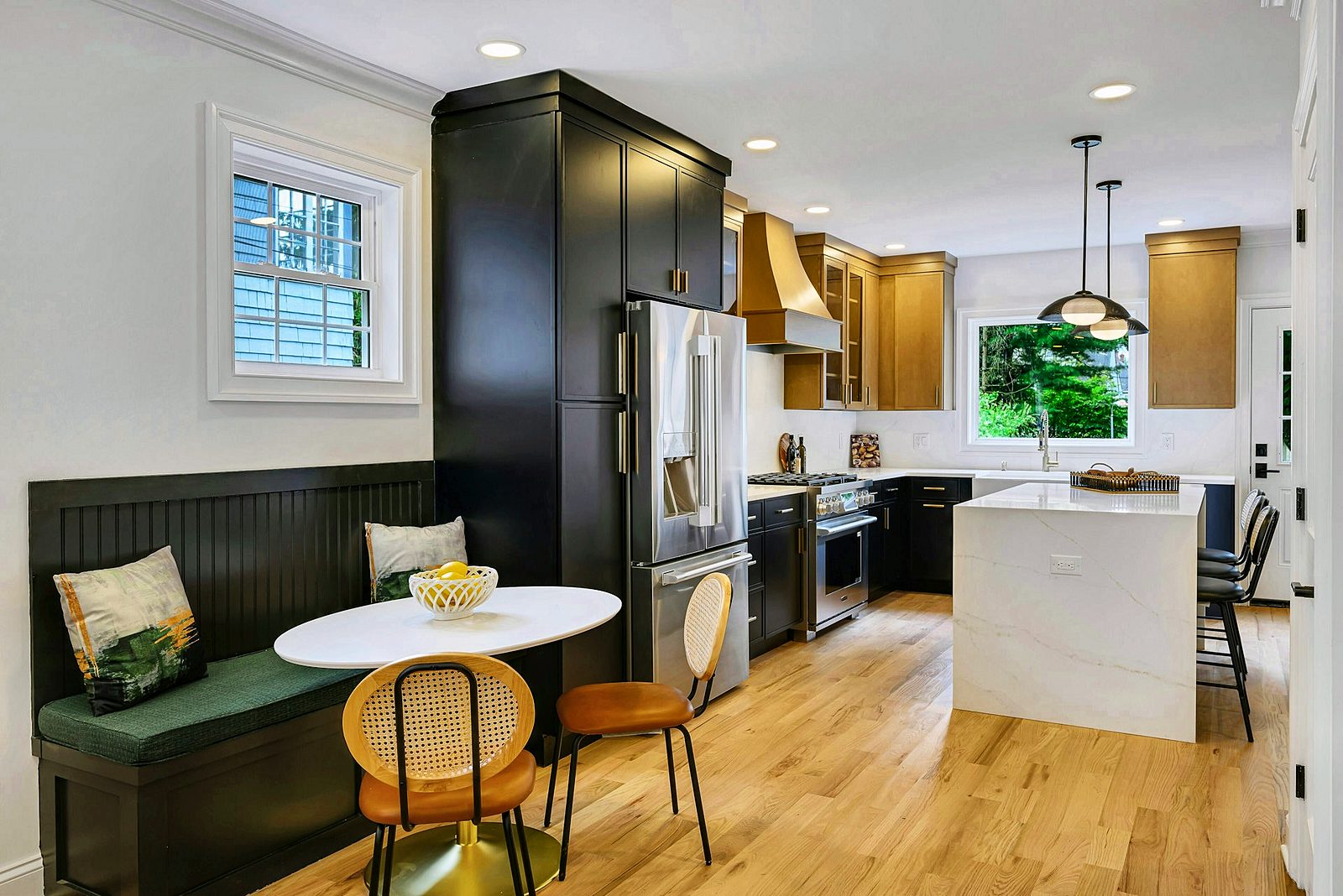 Breakfast nook with green banquette and black bar