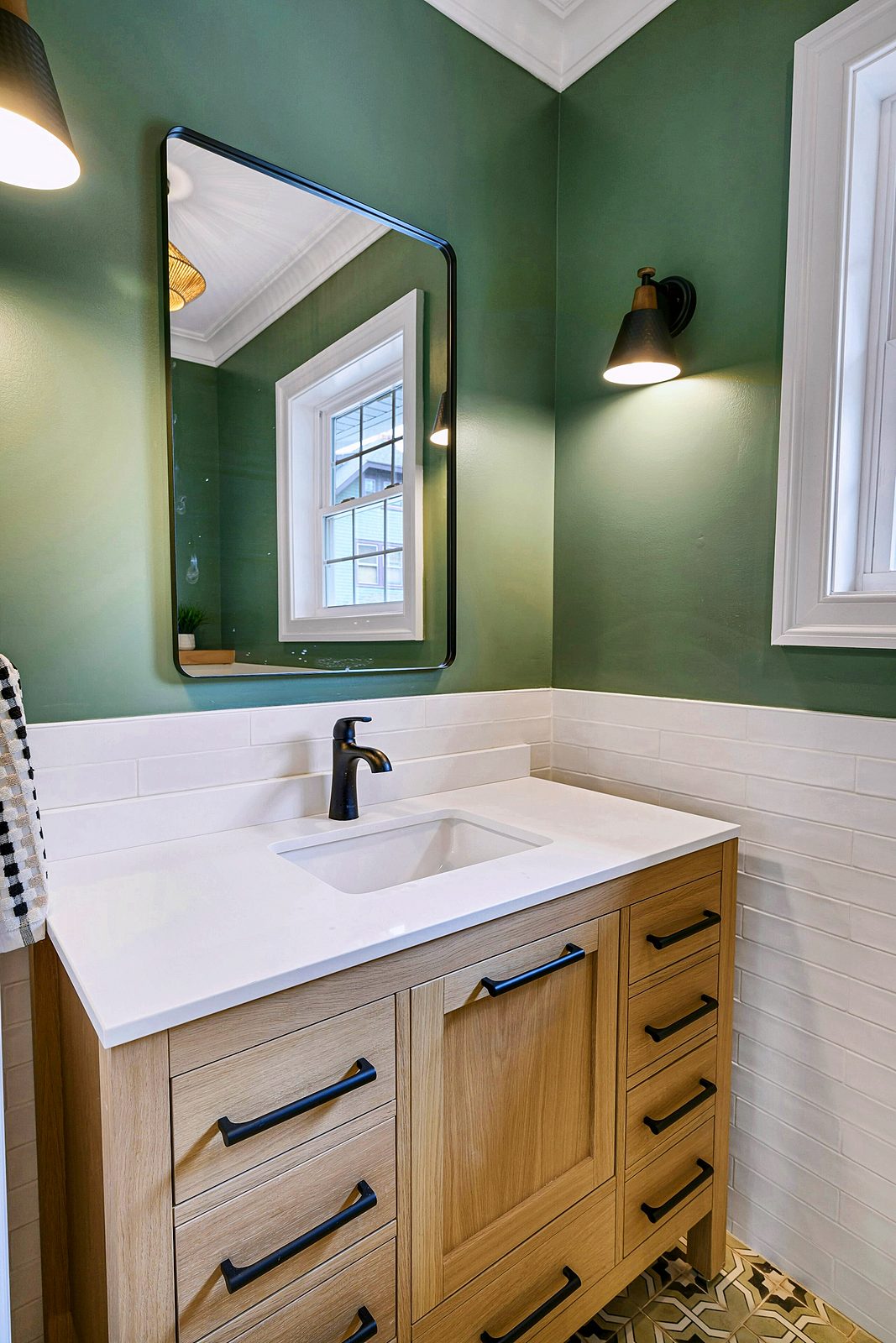 Oak vanity against green walls