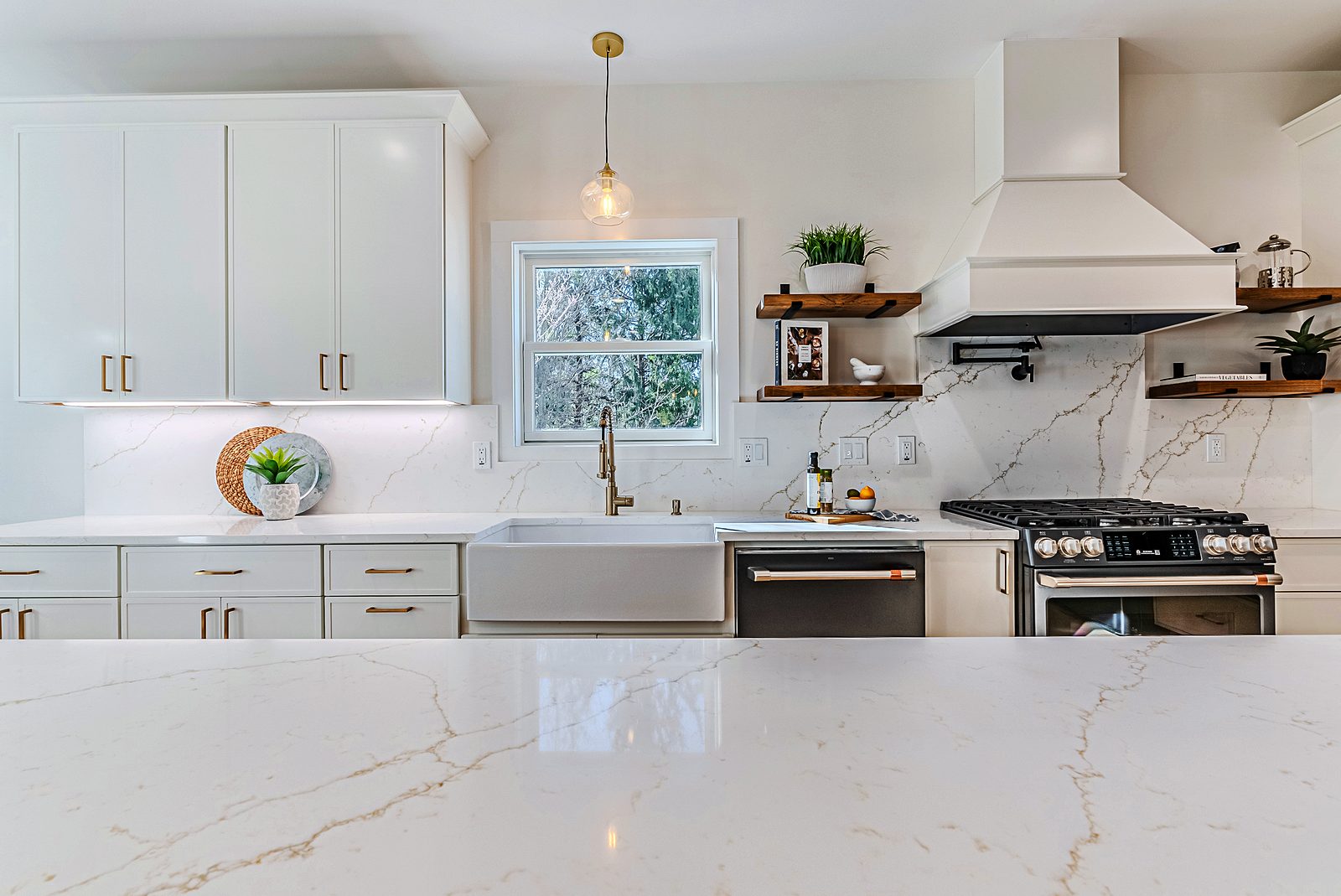 Range wall with white hood and floating shelves