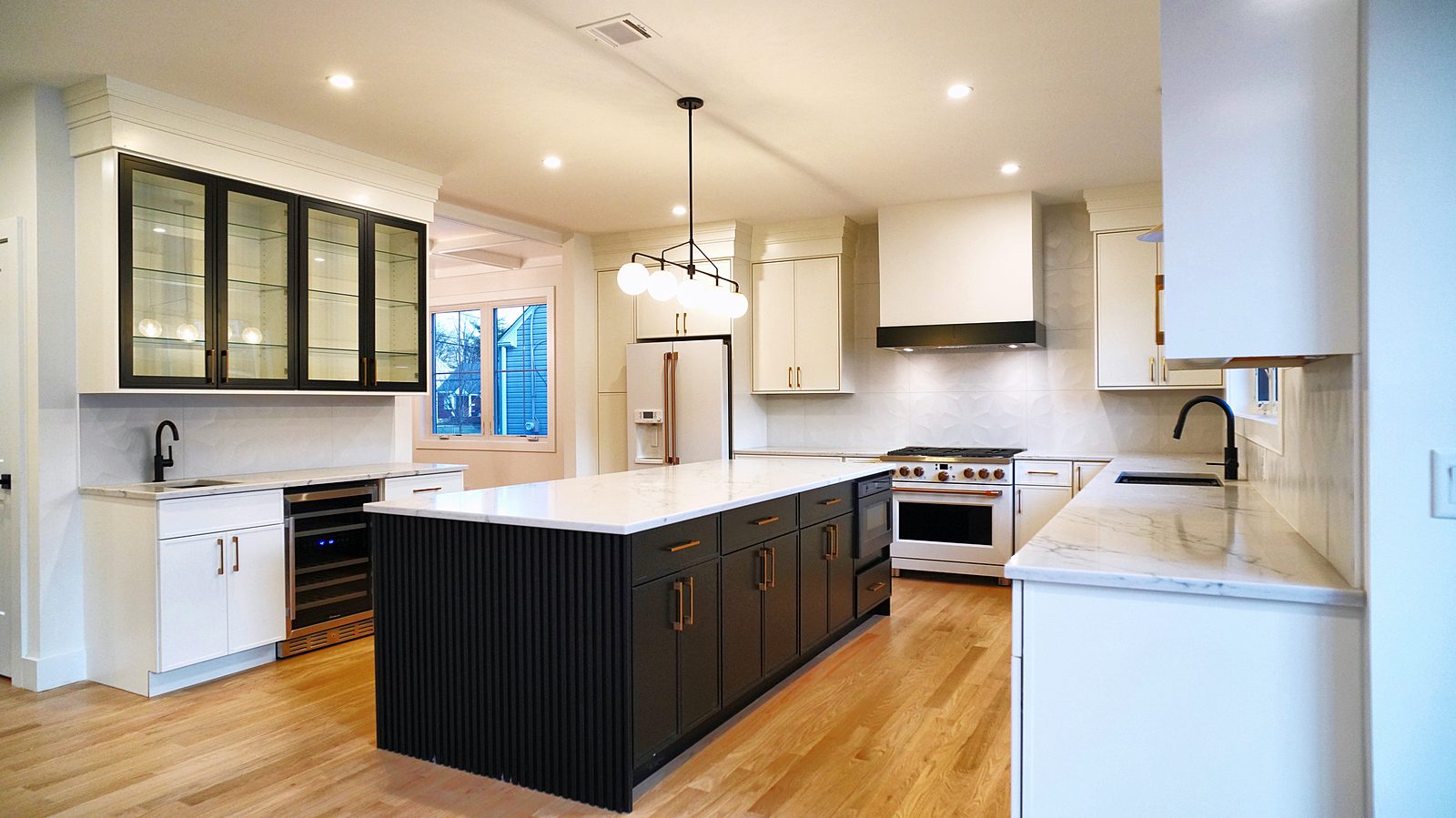 Kitchen with black-framed glass bar uppers and Café appliances