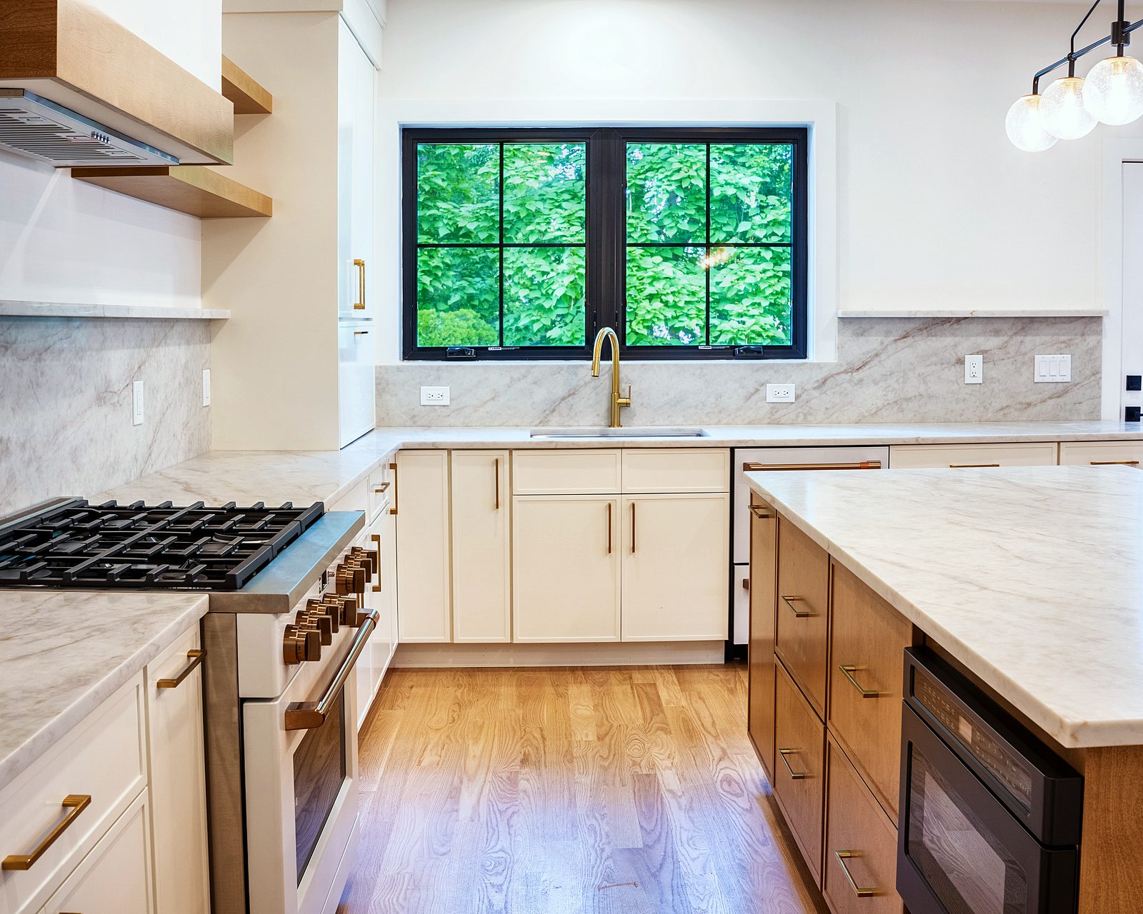 Range with black-framed window and brass faucet