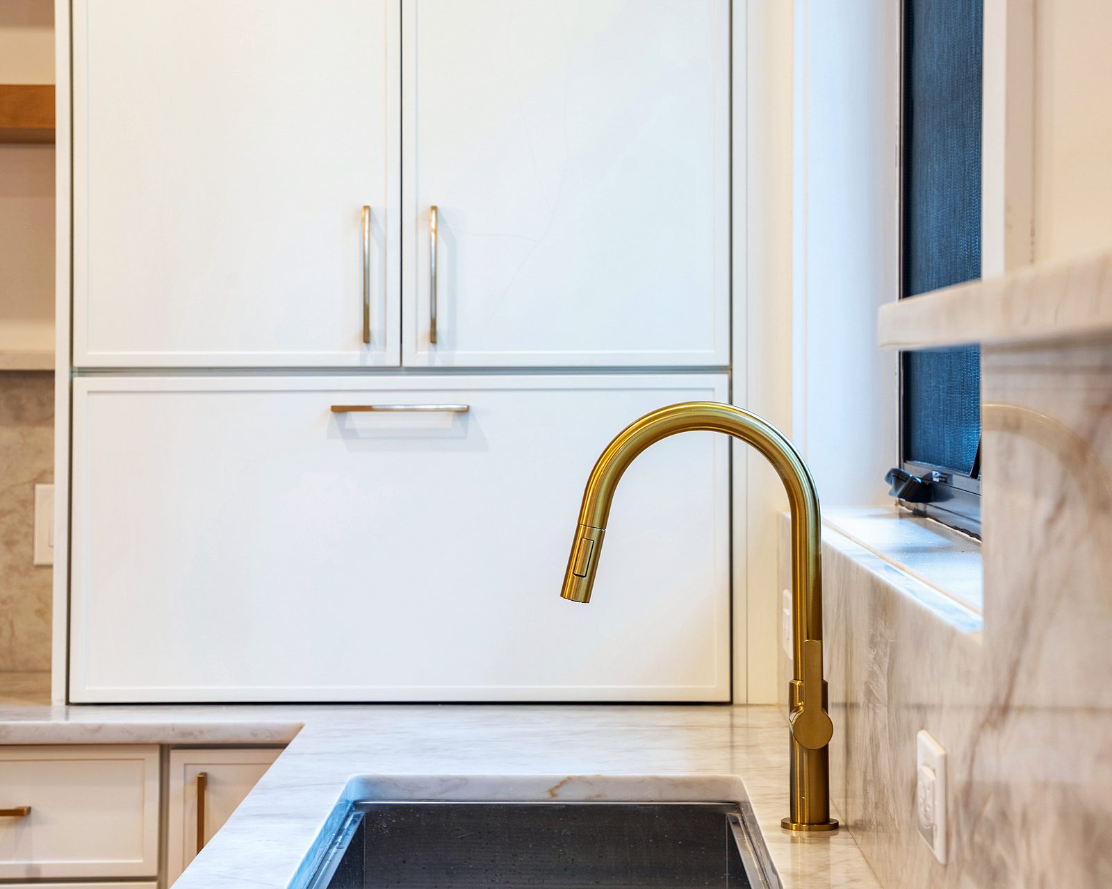 Brass faucet detail with oak panel