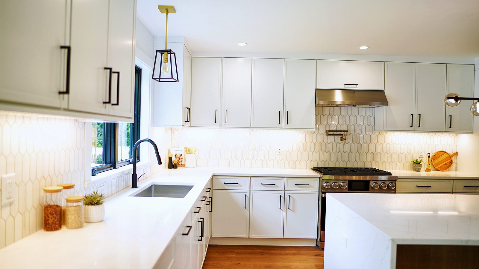 Sink wall with picket tile and black faucet