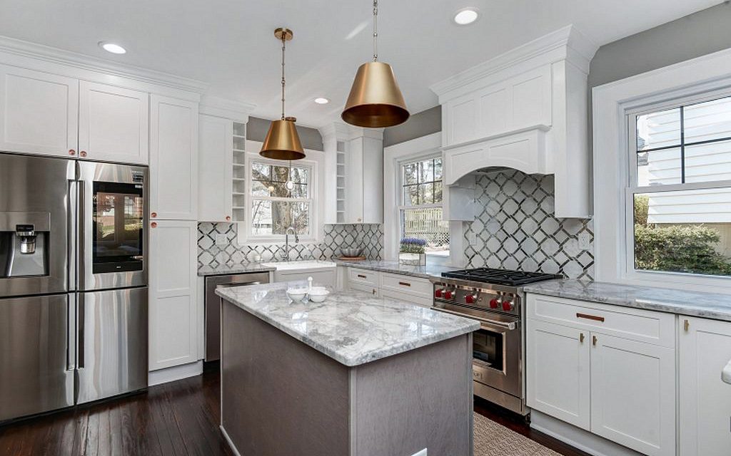 Fabuwood Galaxy Frost and Horizon kitchen with brass dome pendants and arabesque tile