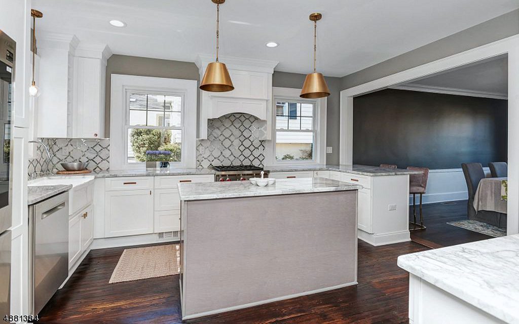 Gray arabesque tile backsplash — Fabuwood Galaxy Frost and Horizon kitchen with brass dome pendants and arabesque tile