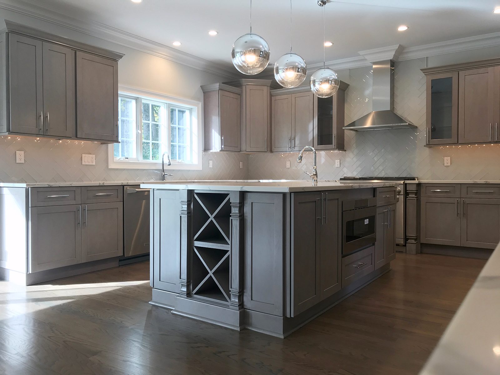 Mirrored-globe pendants — Fabuwood Galaxy in Horizon gray with a wine-rack island
