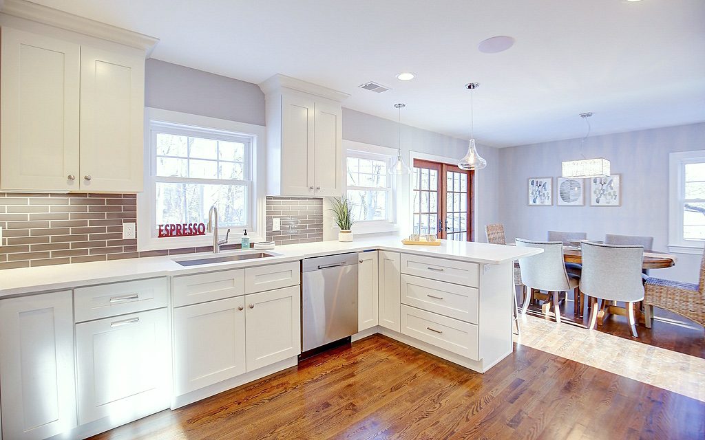 FGM Mercury White perimeter and peninsula (archive label) — FGM Mercury White kitchen with gray subway tile and an open dining room