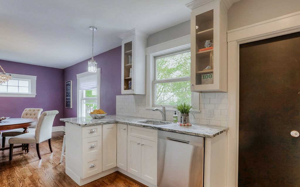 FGM Mercury White kitchen with gray subway tile and an open dining room — photo 6