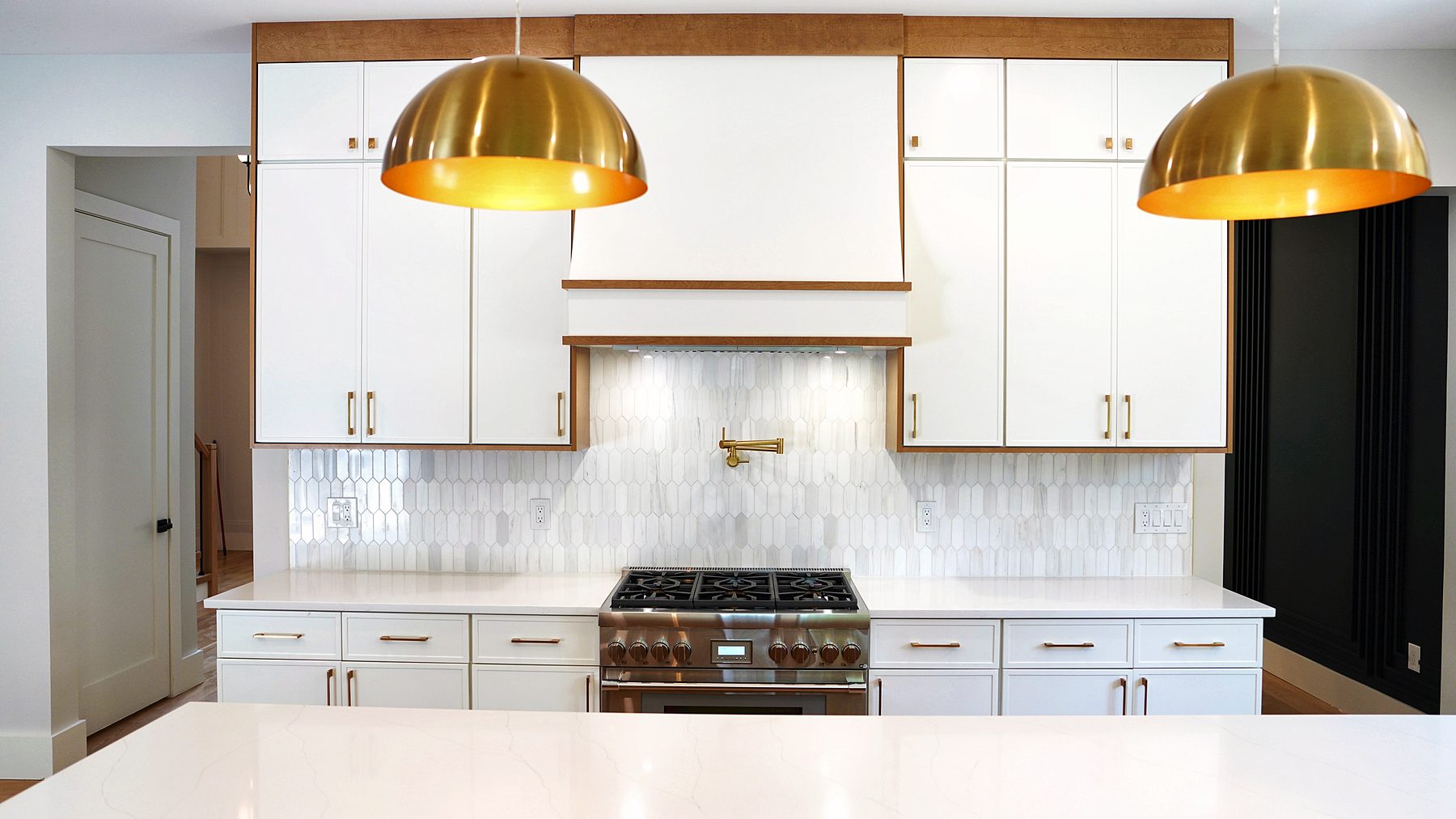 Dove Luna kitchen with Timber hood and brass dome pendants