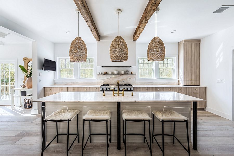 Light wood slab kitchen with a white waterfall island and rattan pendants