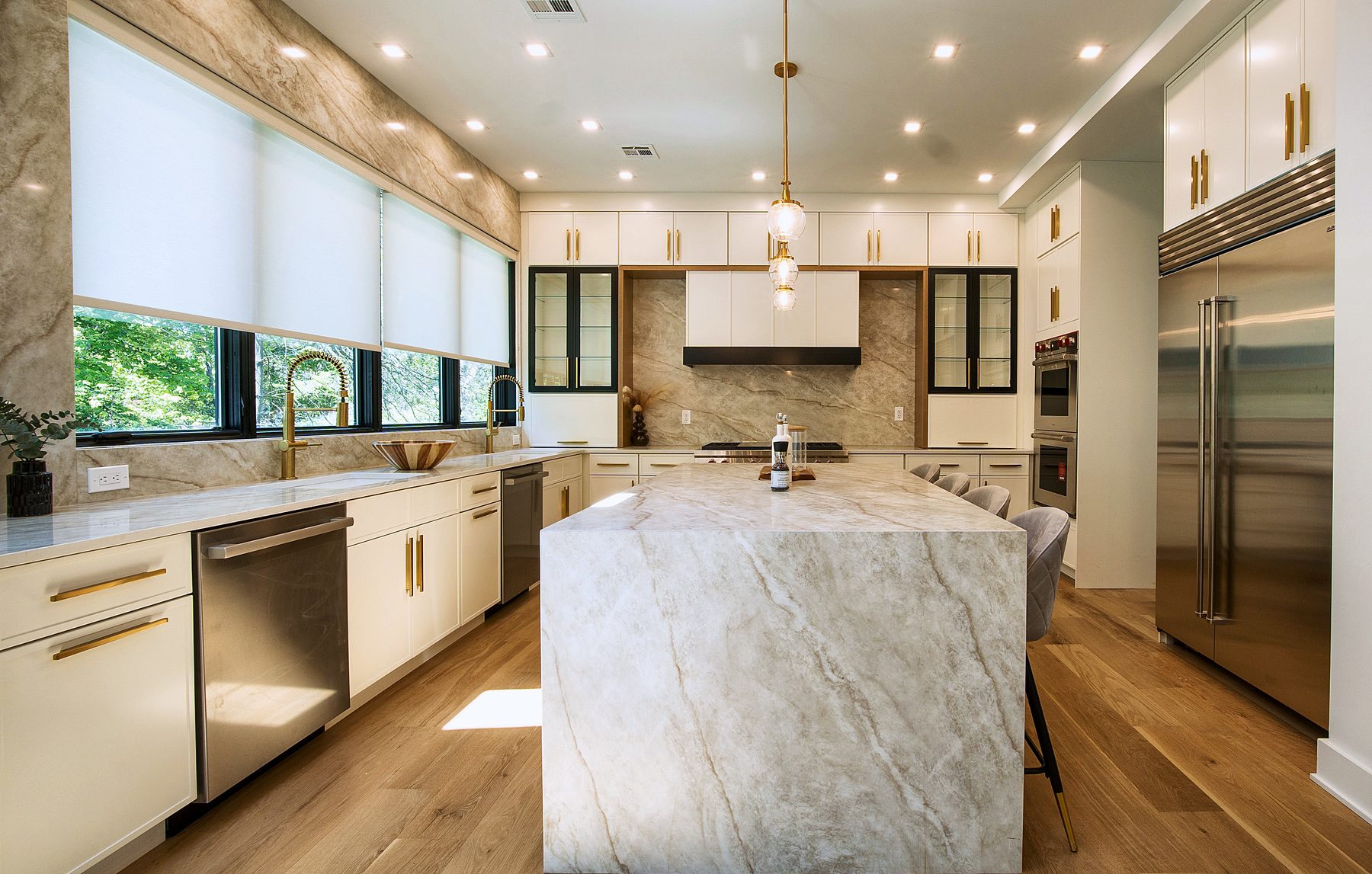 Quartzite waterfall island in a Dove Luna kitchen with Timber accents