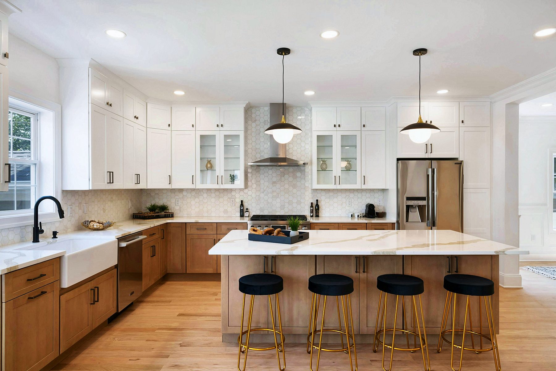 White shaker kitchen with oak island and Calacatta quartz