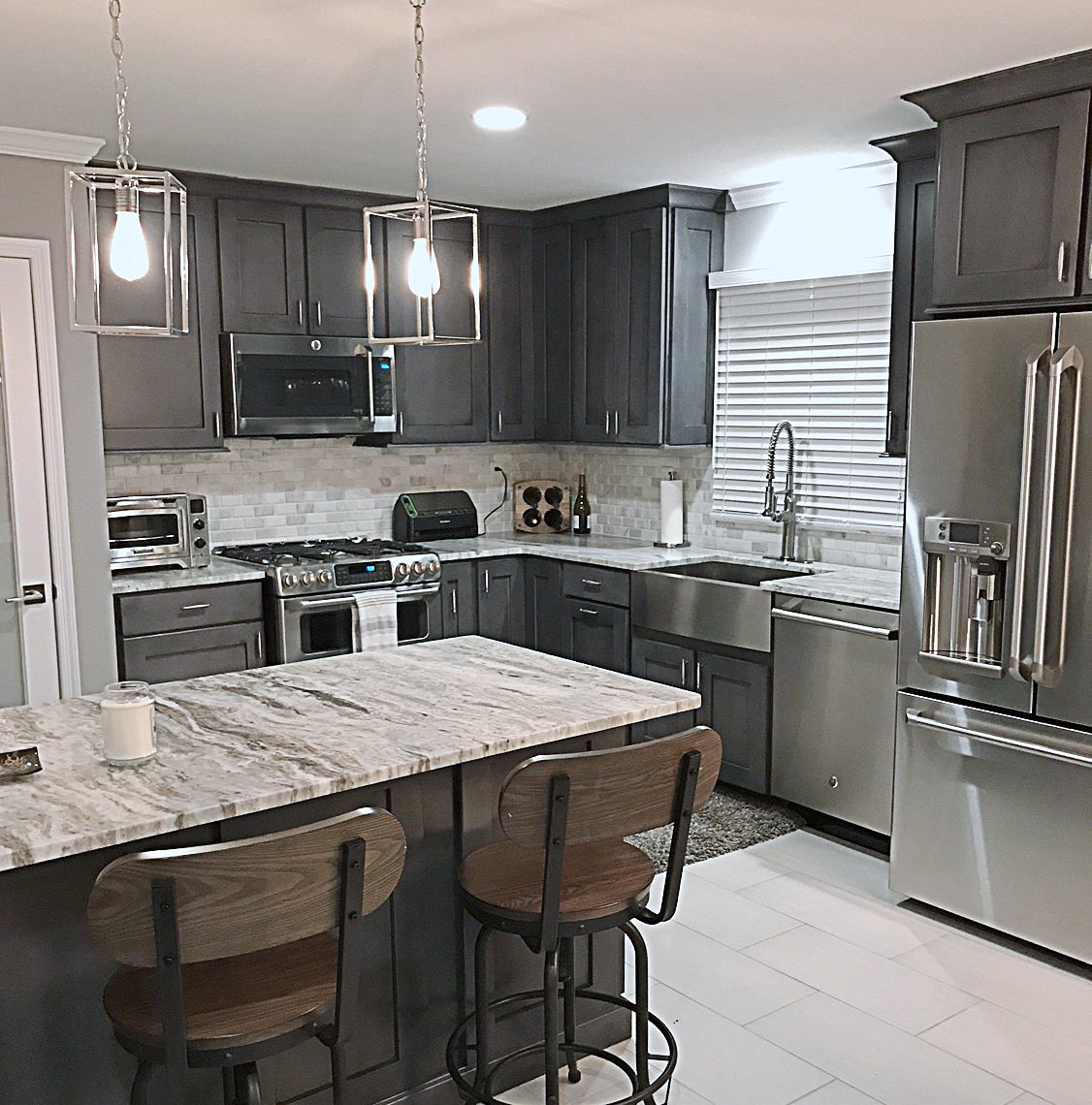 Charcoal shaker kitchen with veined granite and a sputnik chandelier in Morristown, NJ