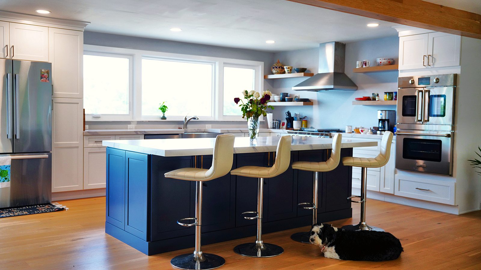 Kitchen with floating shelves and chimney hood