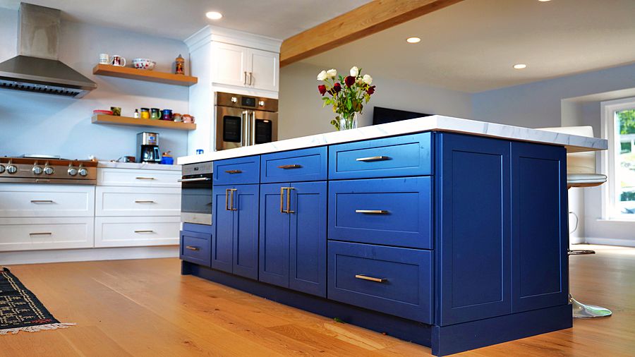 Lake-house kitchen with a navy island and three baths