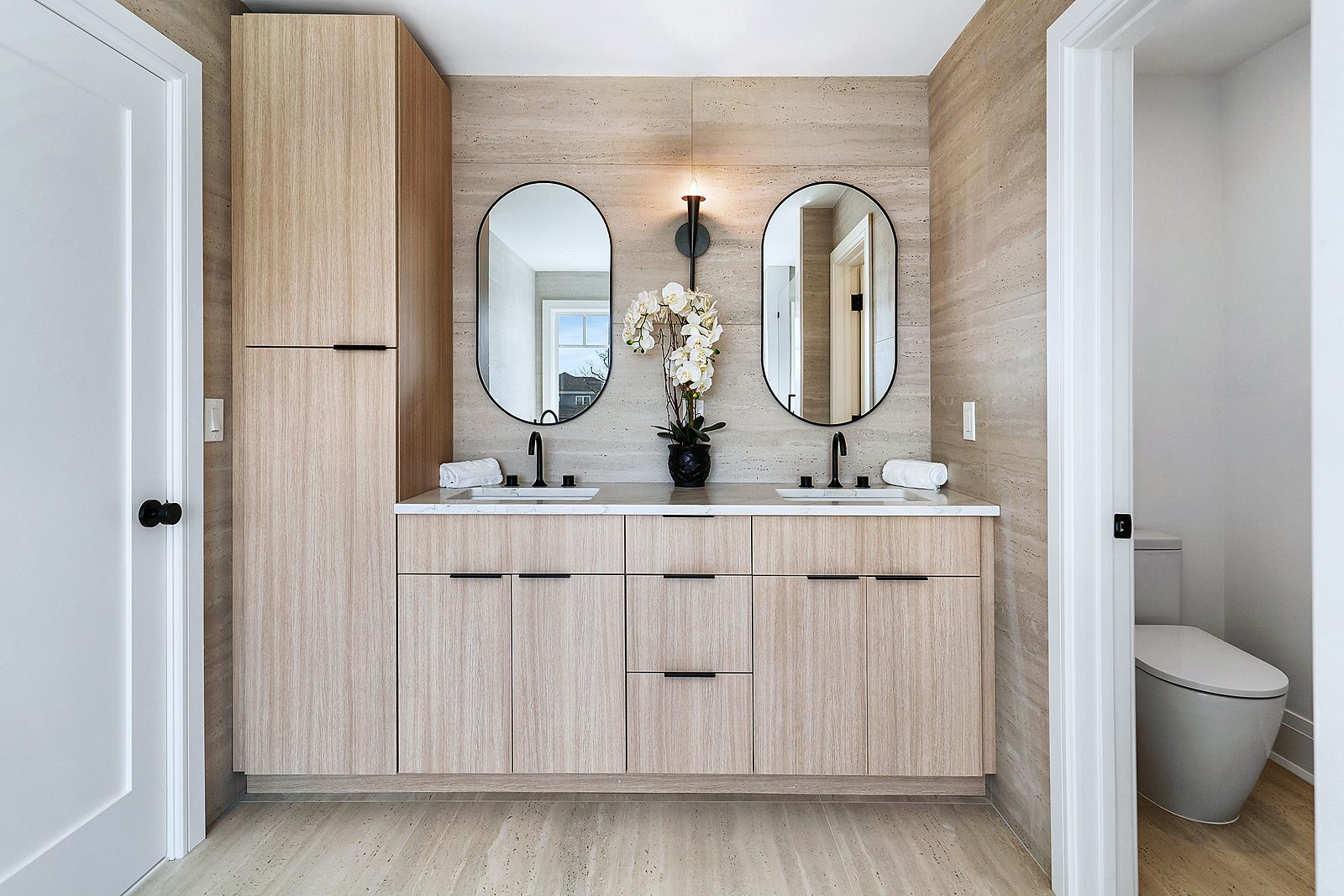 Maple vanity under arched mirrors
