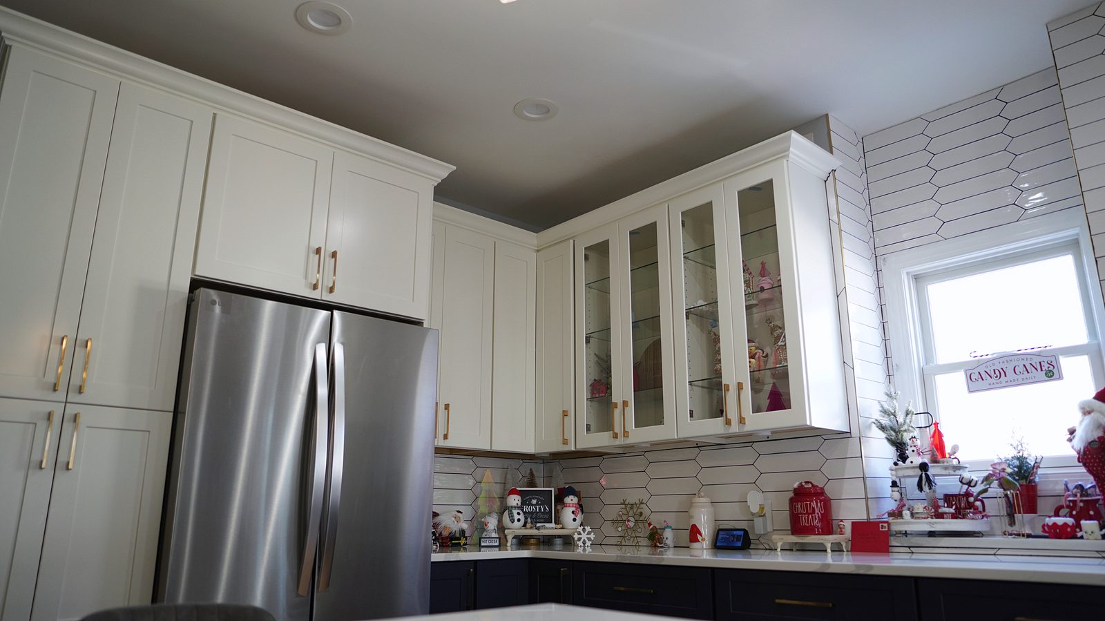 Glass-mullion uppers beside the stainless refrigerator