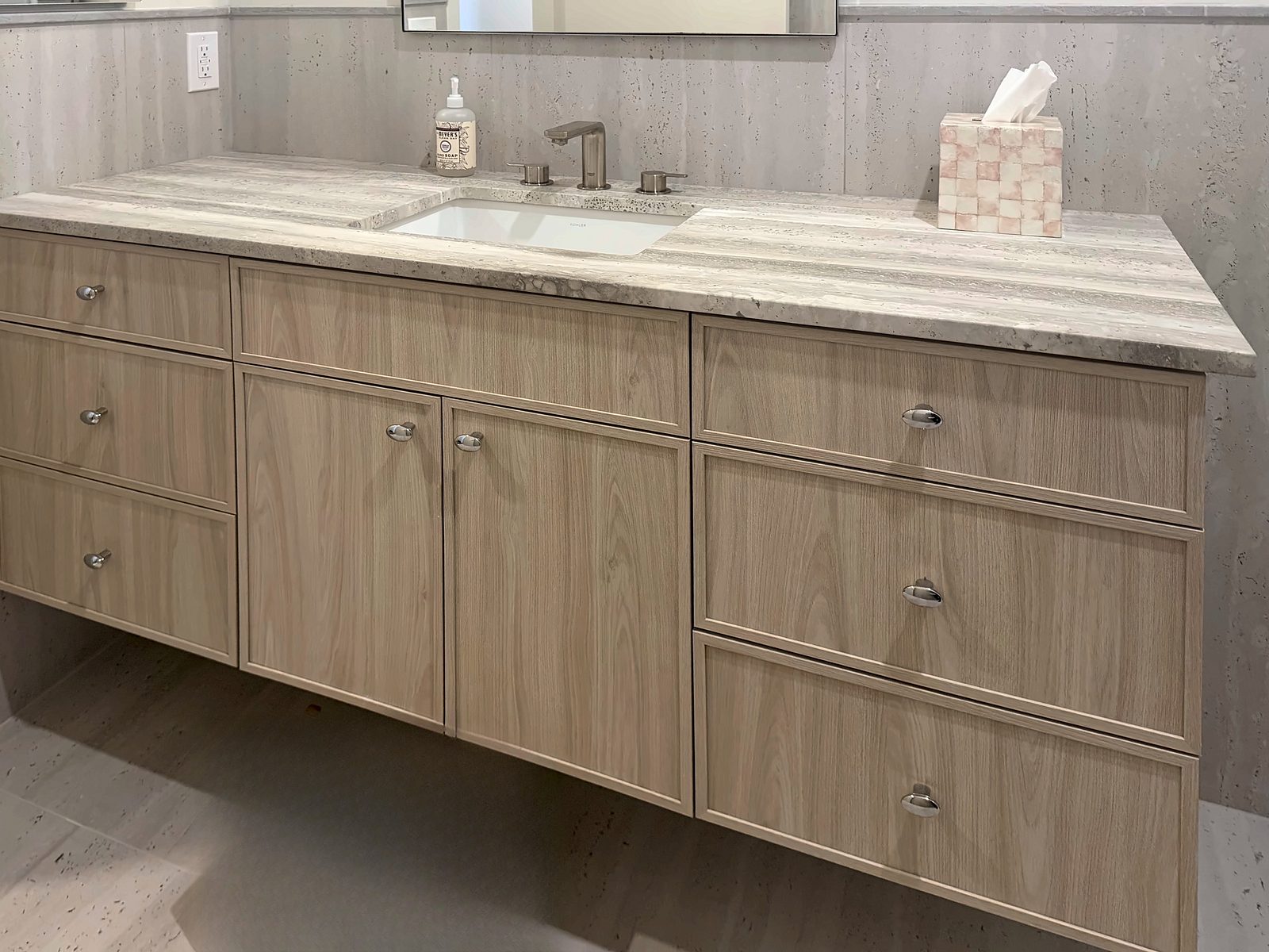 Bath vanity with brushed-nickel cup pulls and an undermount sink