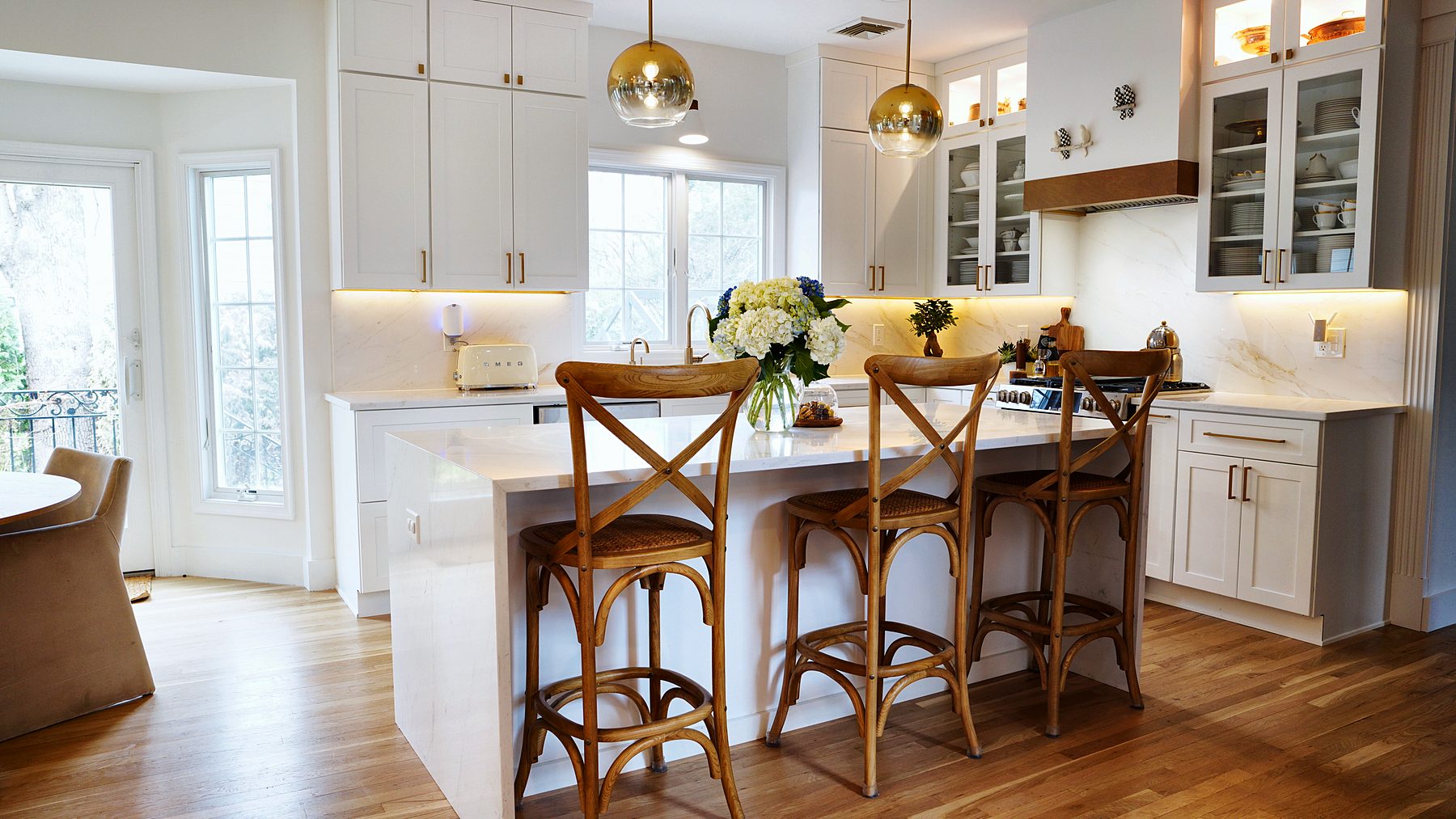 Galaxy Dove kitchen with waterfall island and cross-back stools