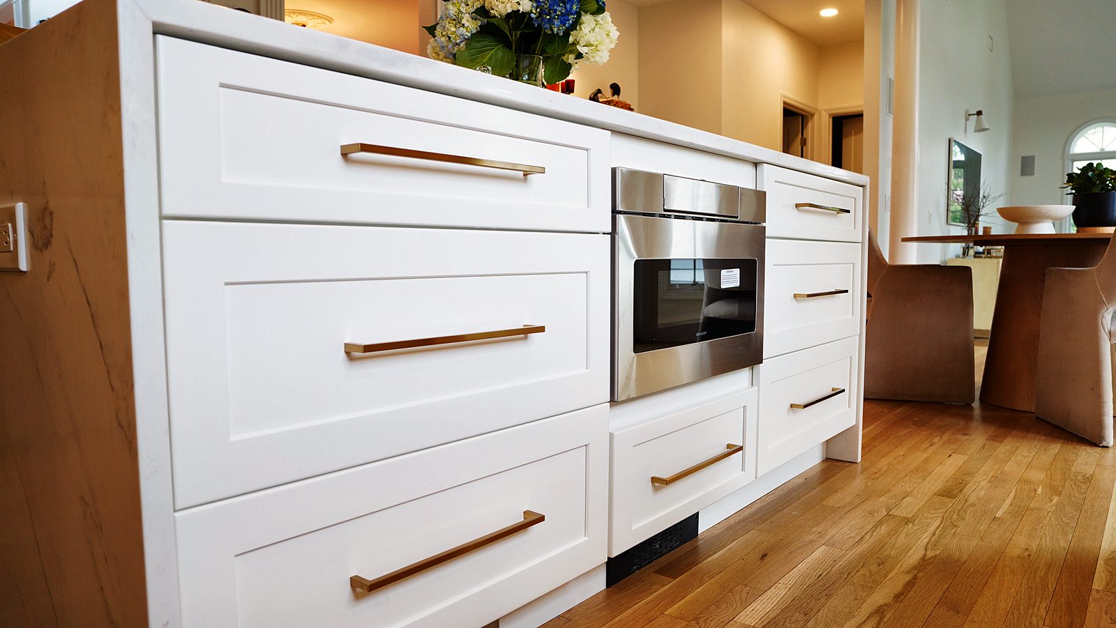 Island drawers with brass pulls and microwave drawer
