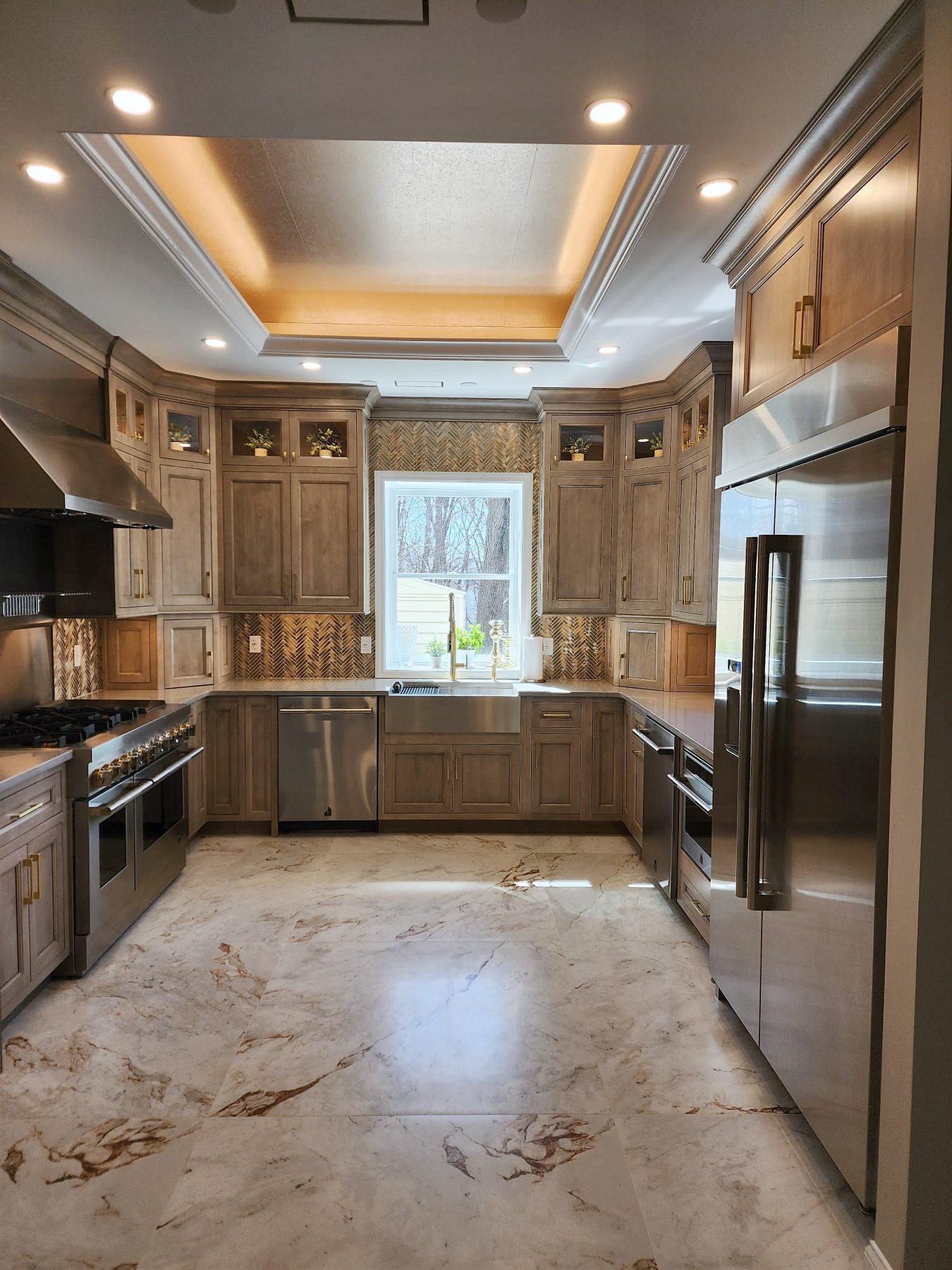 Shiloh Aspen inset kitchen in a brown stain with a lit bar wall and a butler’s pantry