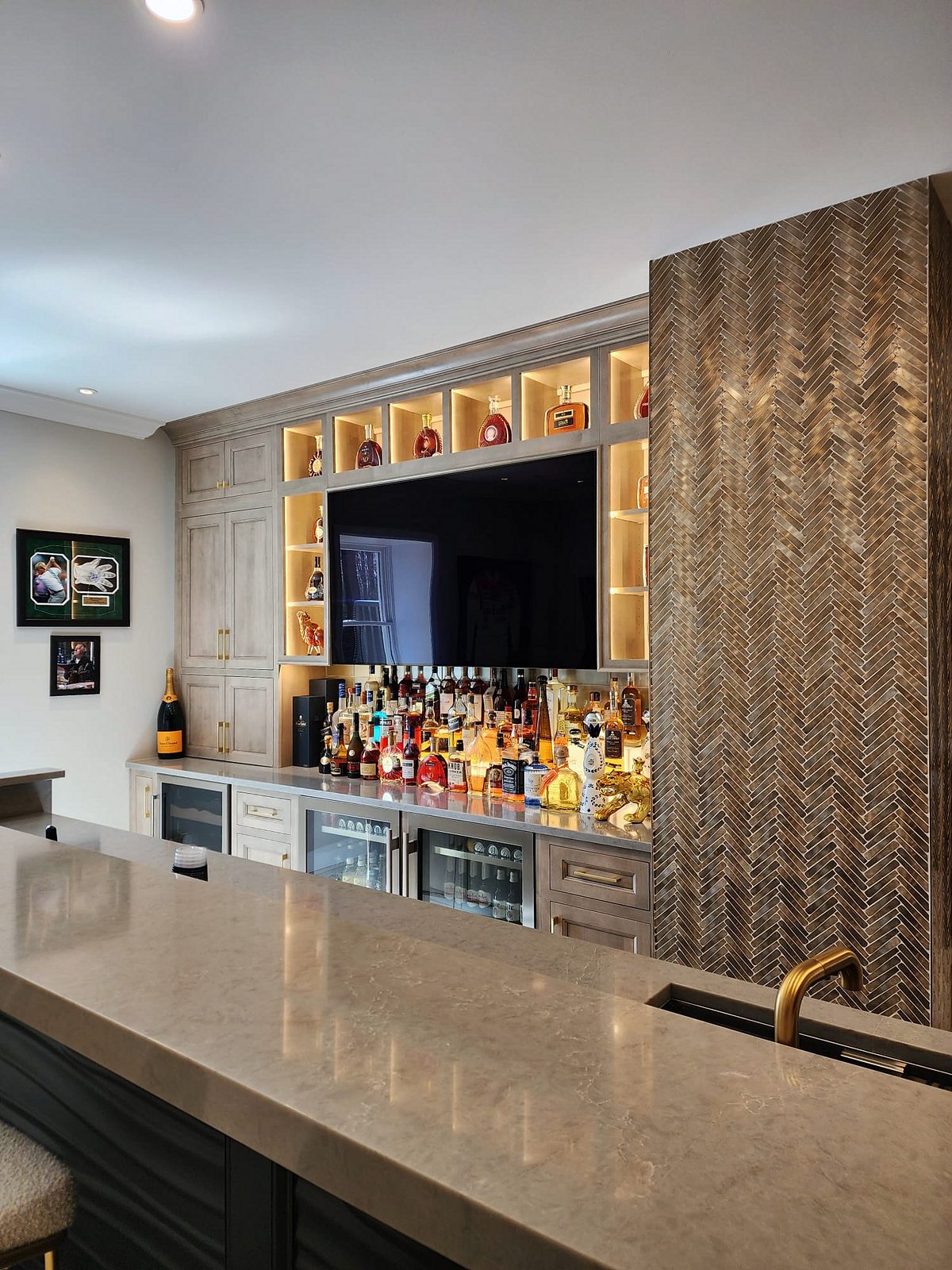 Tray ceiling with cove lighting; corner appliance garage — Shiloh Aspen inset kitchen in a brown stain with a lit bar wall and a butler’s pantry