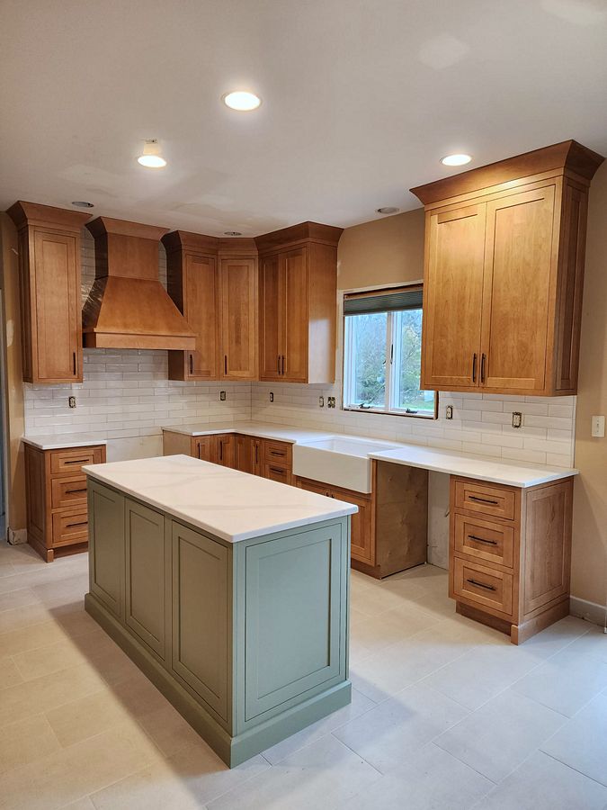 Shiloh Hanover kitchen in a light brown stain with a green island