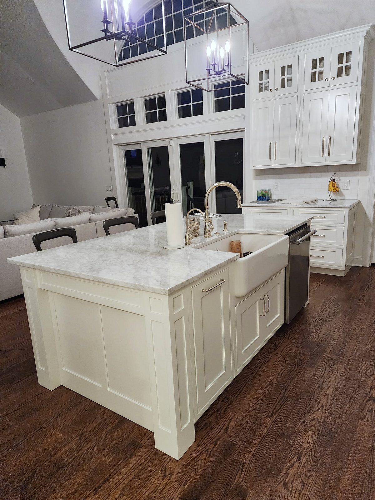 Vaulted ceiling, arched window, curved white hood — Shiloh Heritage beaded-inset kitchen under a vaulted ceiling with a curved hood