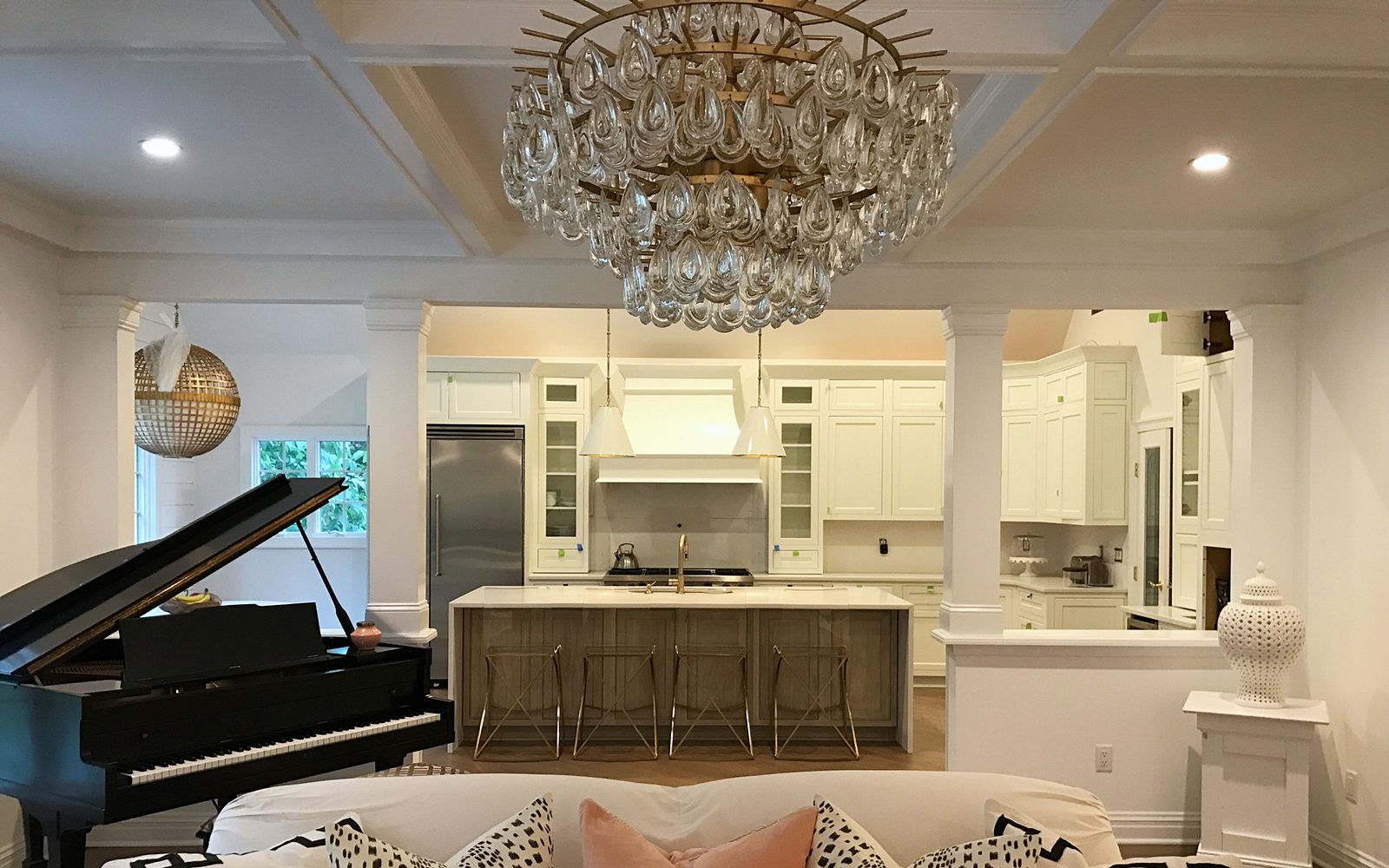 Marble-look slab, veined white quartz — Shiloh Heritage kitchen in Polar and Seagull with a bench island and a gray wood hood