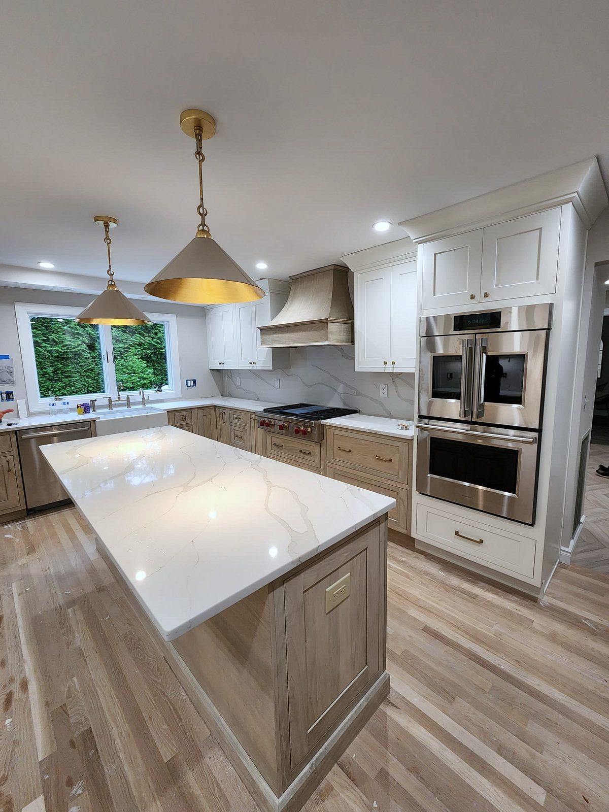 Herringbone marble backsplash run full height — Shiloh Heritage kitchen in Polar and Seagull with a full-height marble backsplash