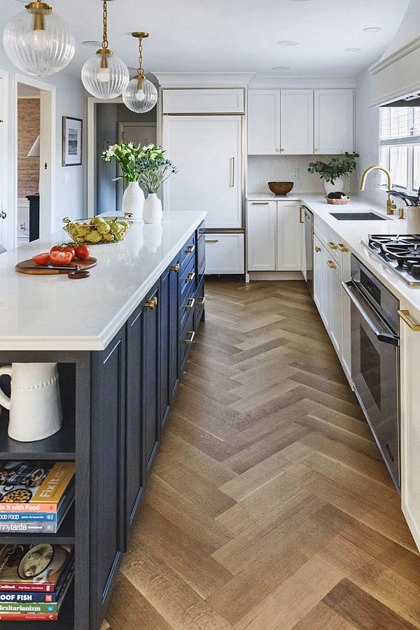 White kitchen with a navy island, designed with Room Therapy