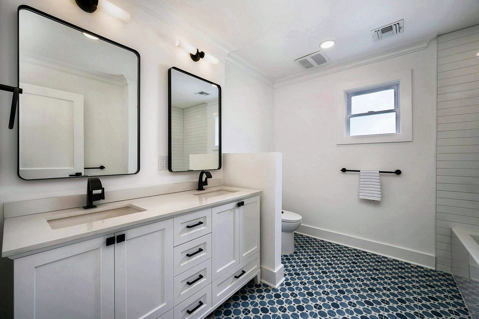 White double vanity with black mirrors
