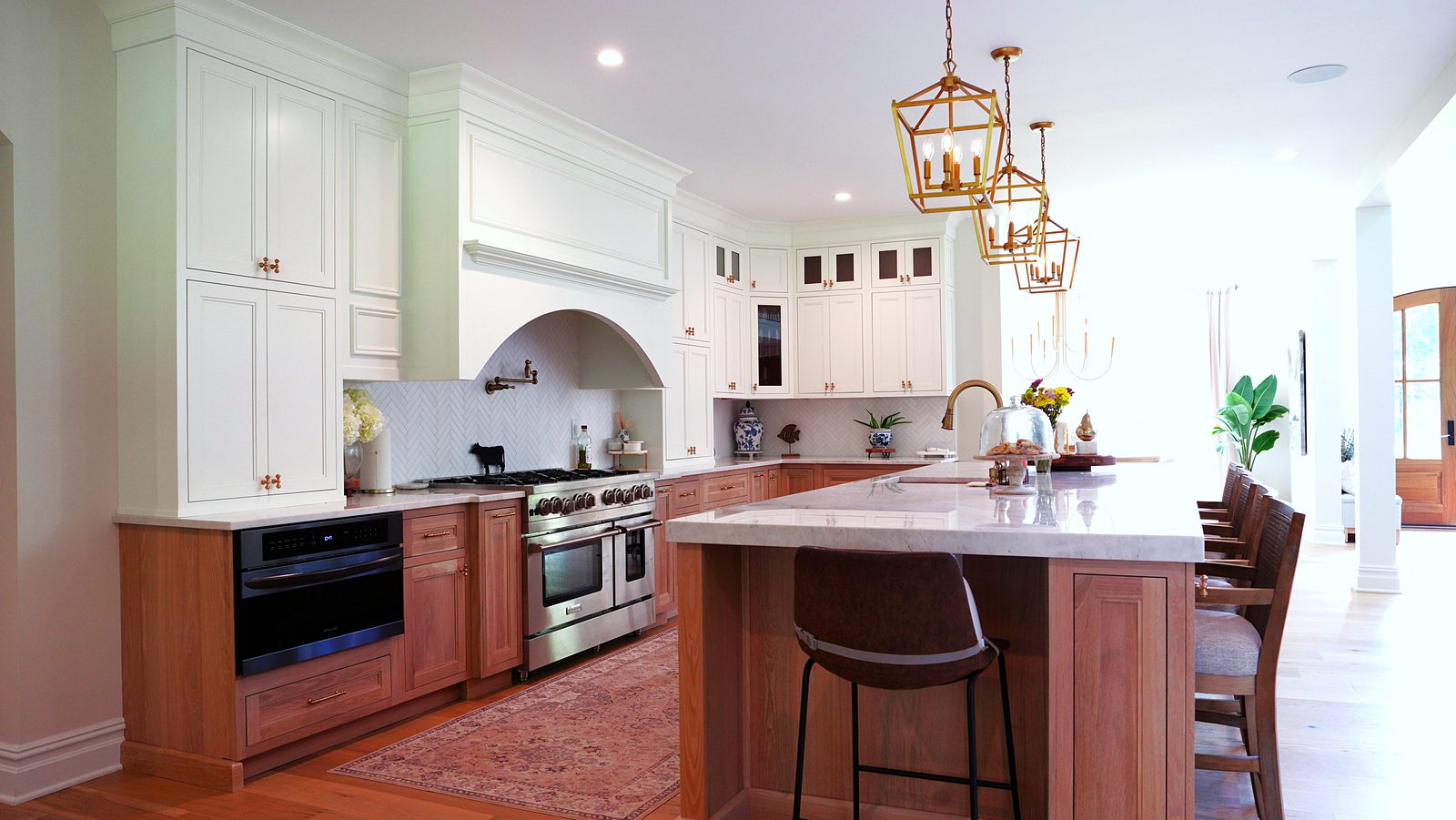 The kitchen from the dining side, with the arch and the stone wall behind the island