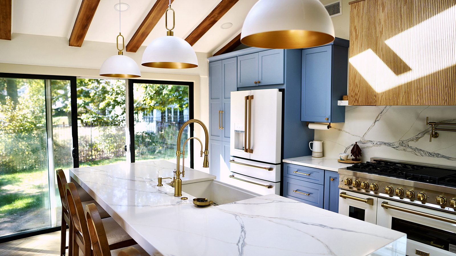Island with cane-back stools and brass faucet