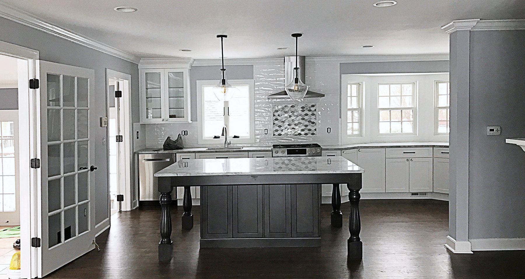 White shaker kitchen with a dark gray furniture-style island in Union, NJ