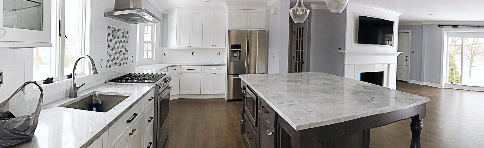 White shaker perimeter with glass-front uppers — White shaker kitchen with a dark gray furniture-style island