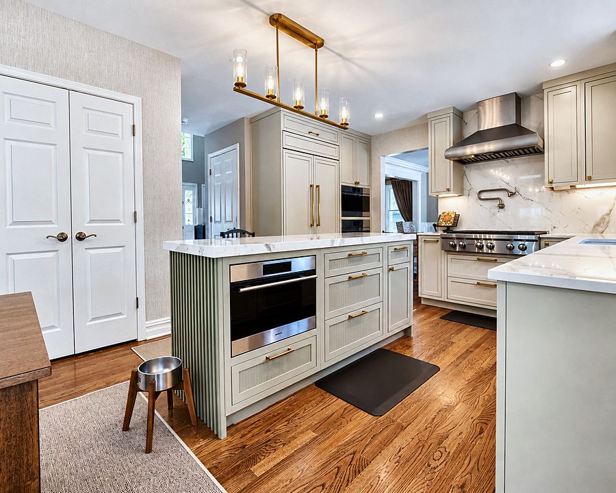 Flush-inset Beige kitchen with reeded Evergreen Fog island and porcelain counters