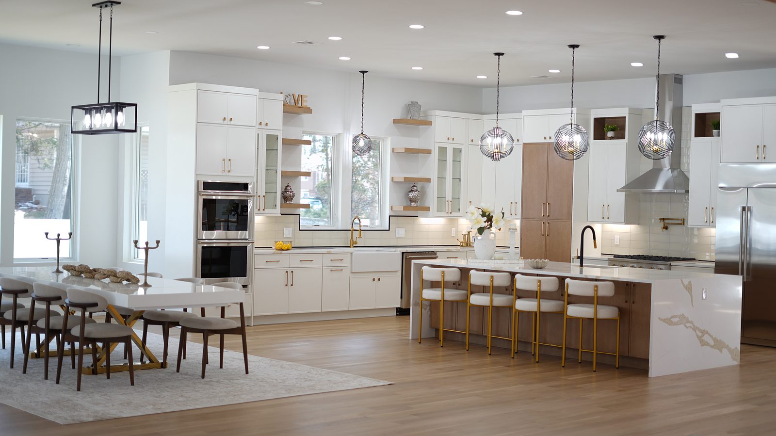 The open kitchen and dining room with the waterfall island and full-height windows