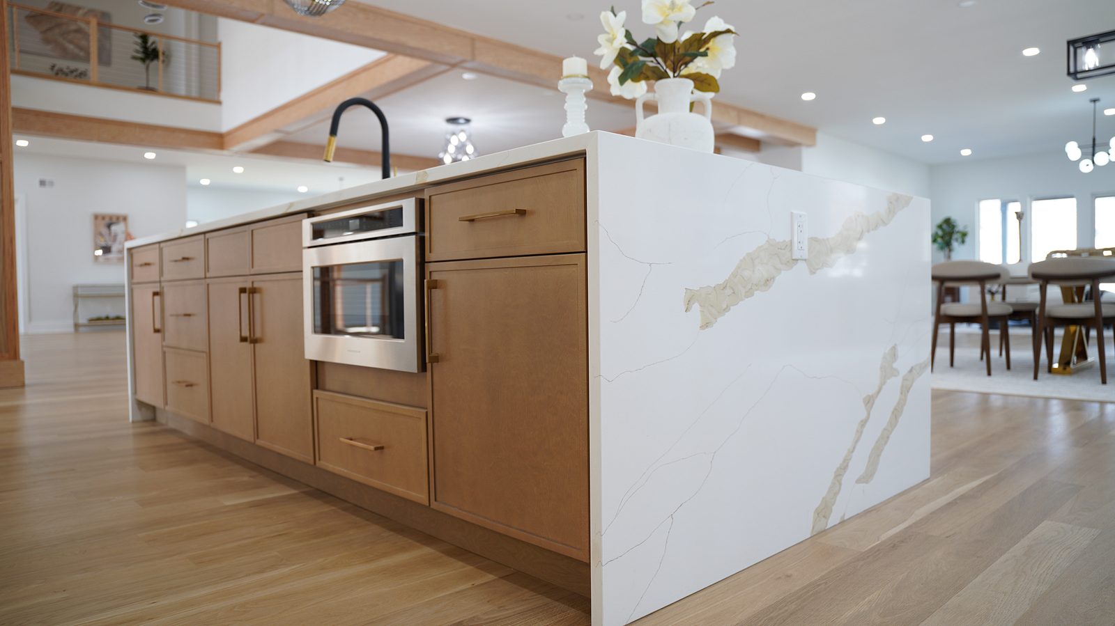 Waterfall end of the island with the microwave drawer in the oak base